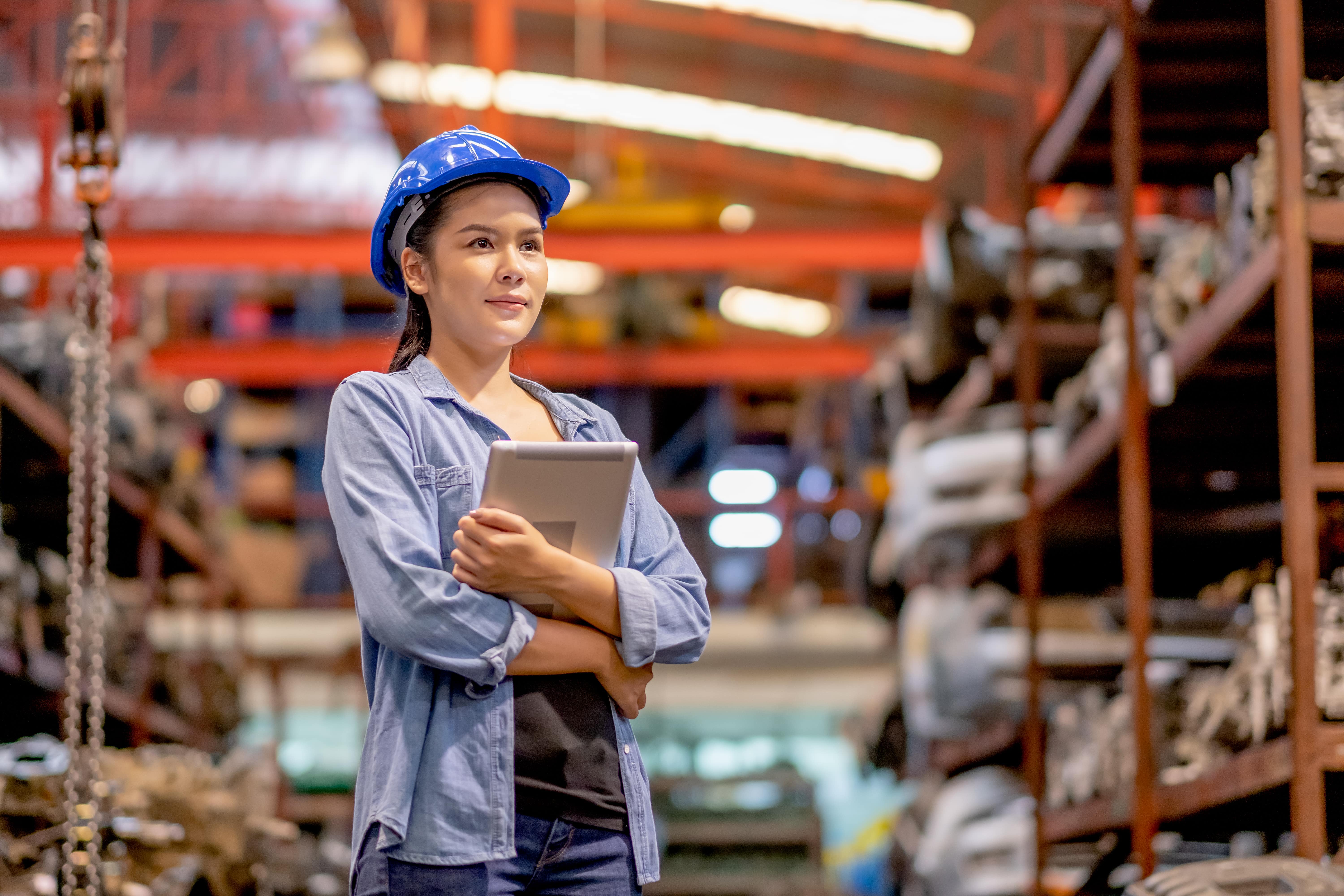 portrait-of-factory-worker-woman-with-blue-hardhat-2021-10-27-14-46-00-utc